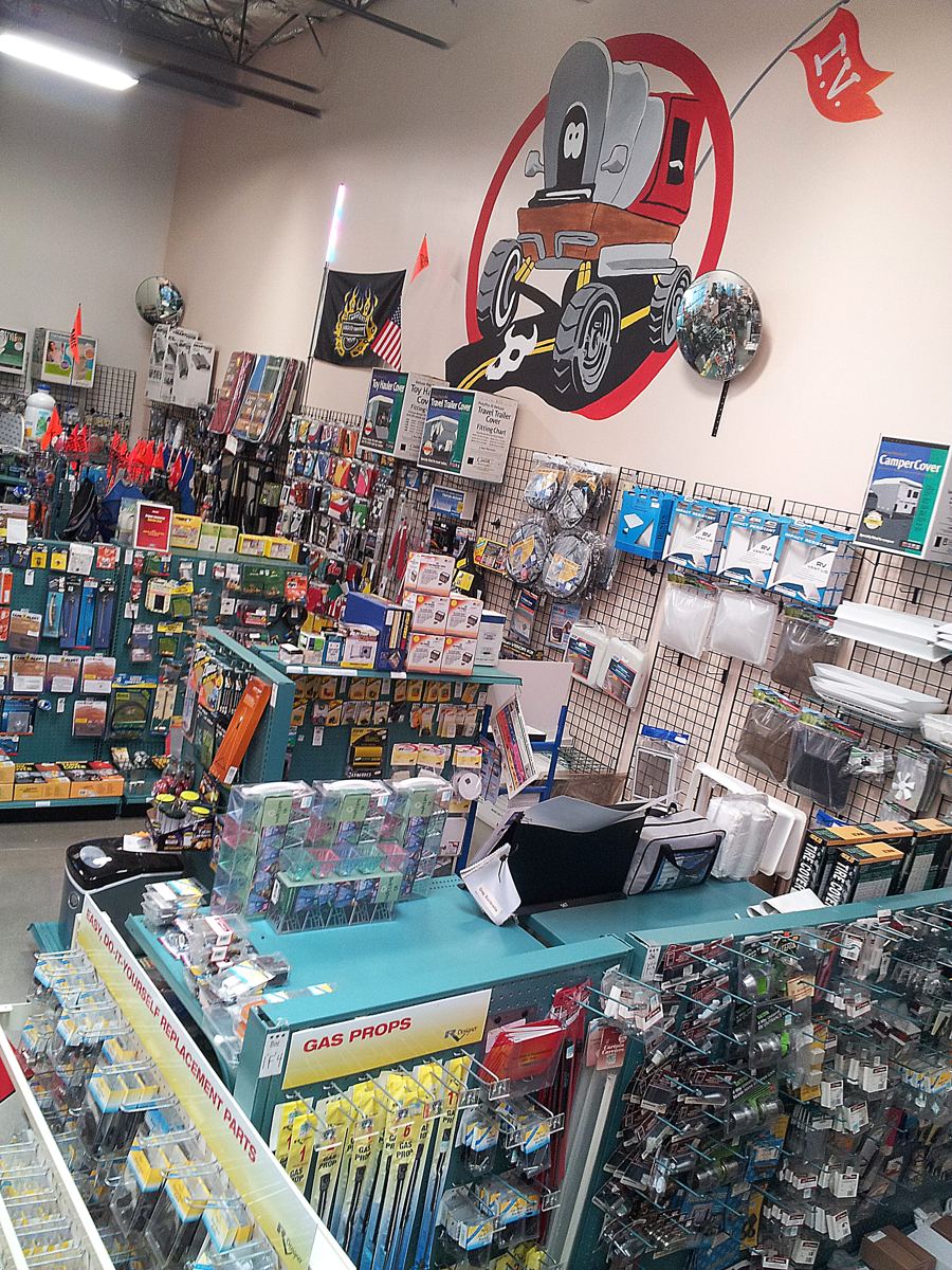 Inland Valley RV store checkout counter with wagon logo mural