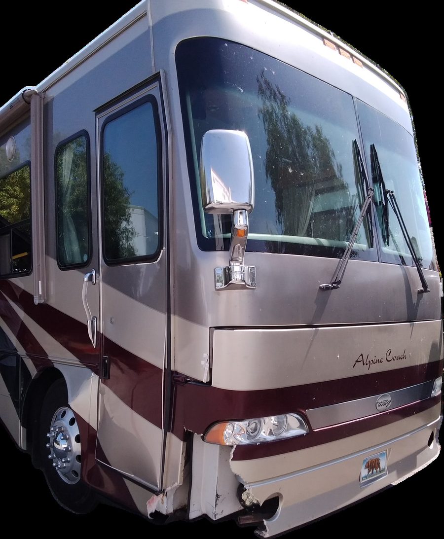 RV front cap and bumper showing collision damage, cracked and dented